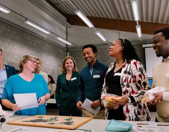 a group of people standing around a desk